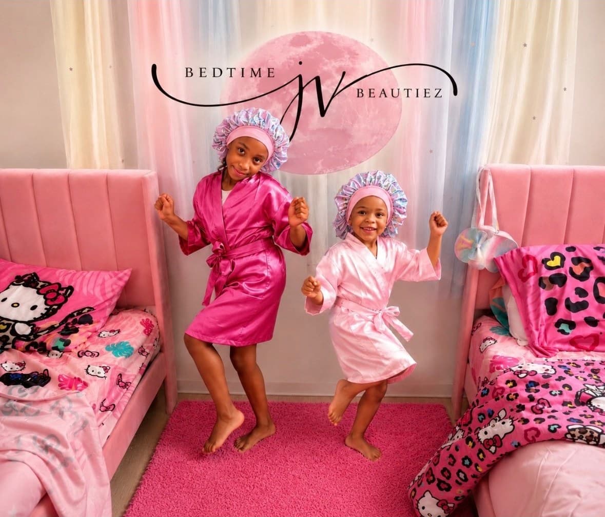 Two girls dancing in matching satin robes and bonnets